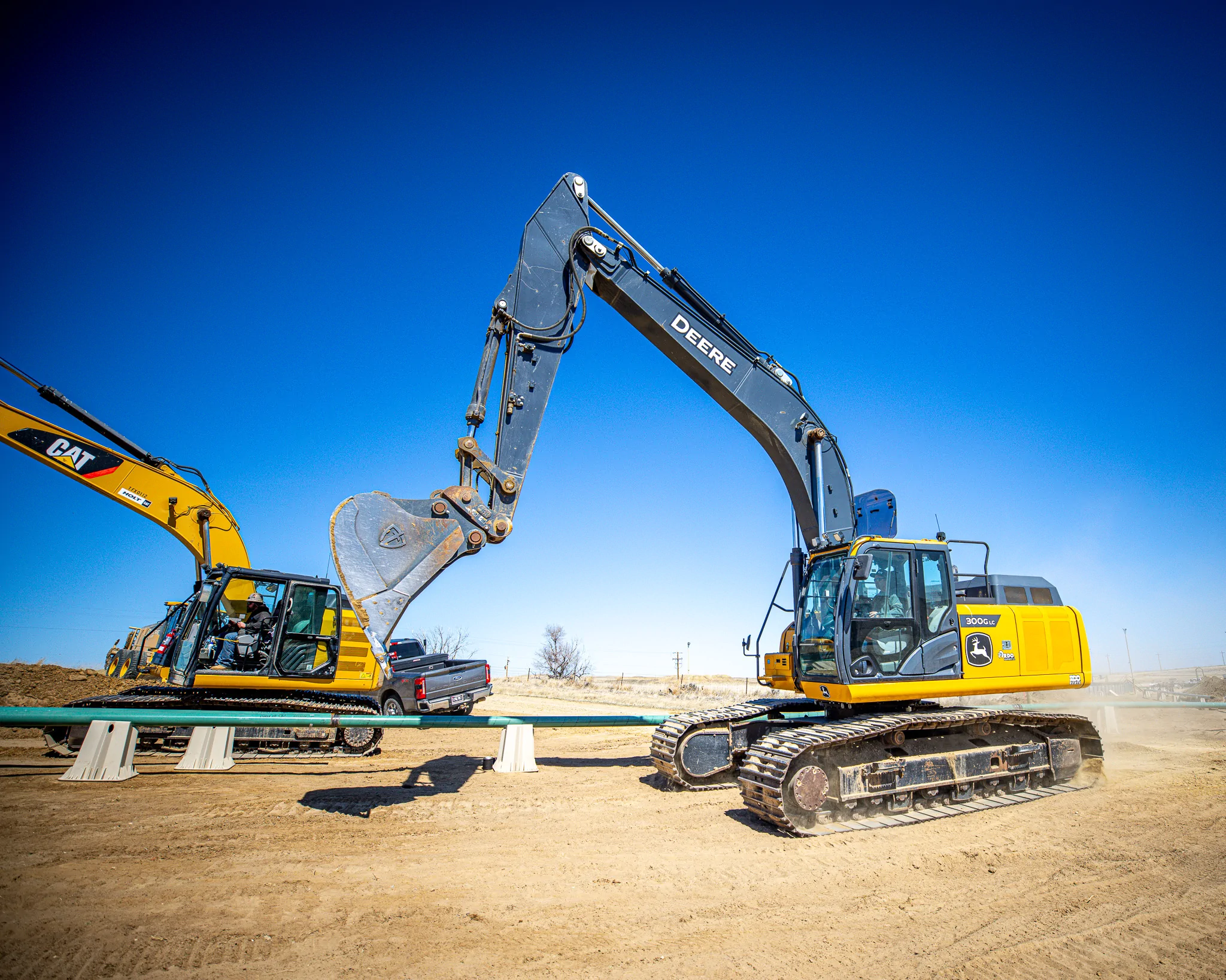 Two excavators on a WYO Services pad construction site