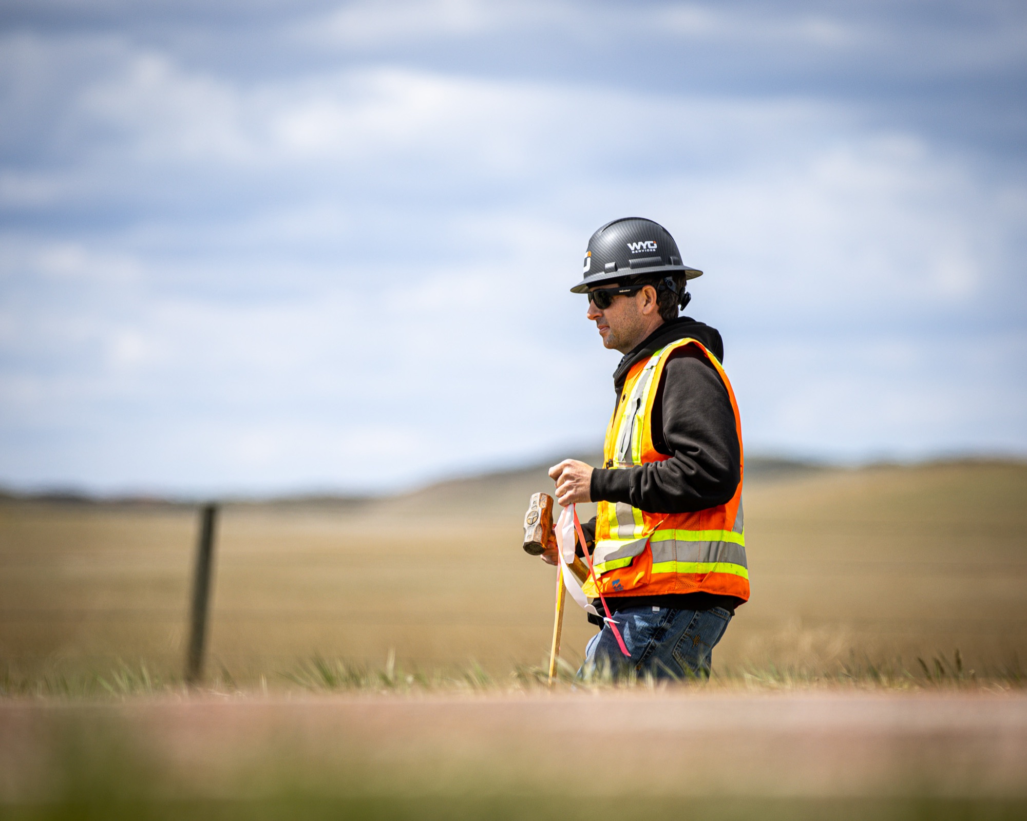 Kyle Materi, owner of WYO Services, marking fence line on Wyoming rangeland