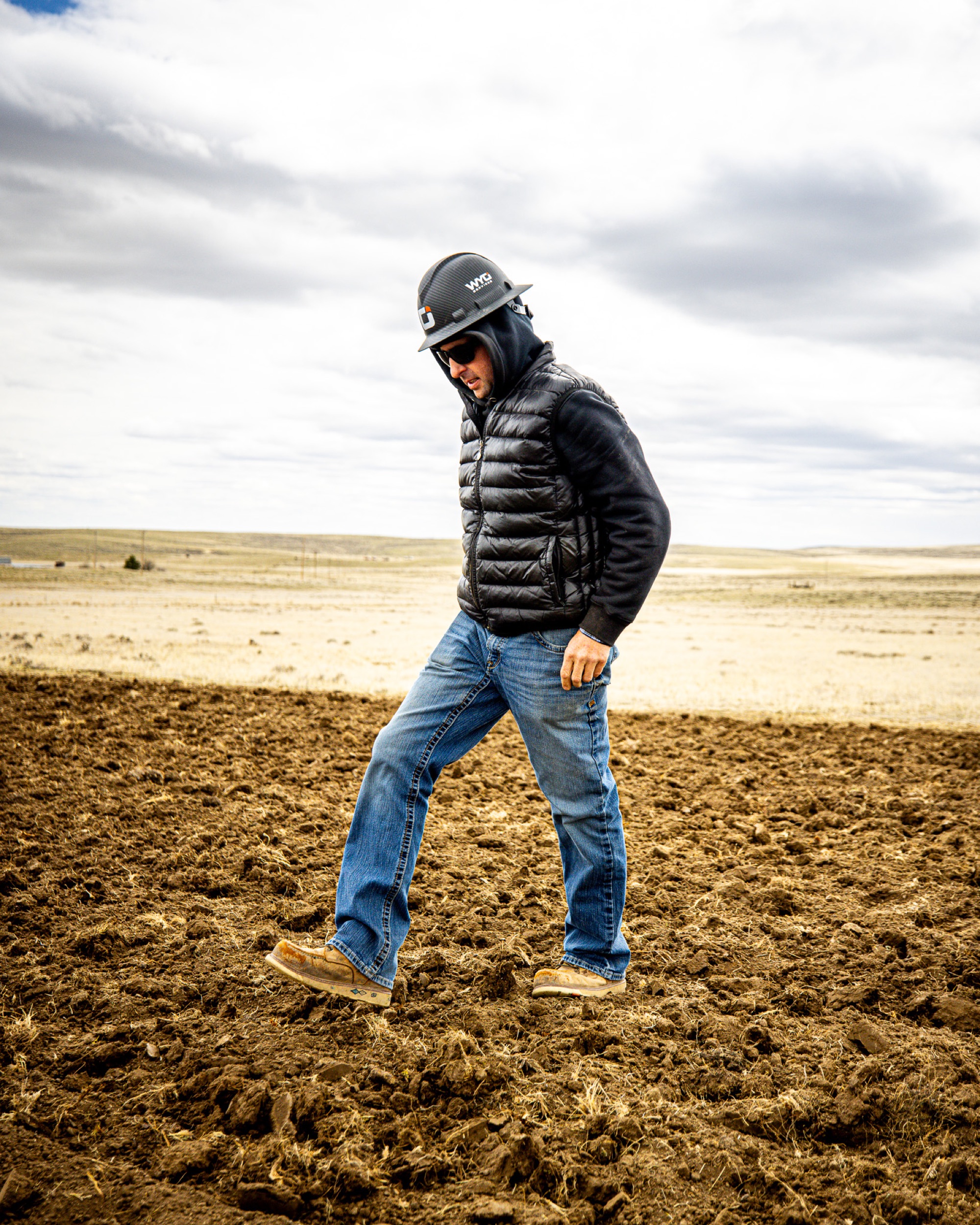 Kyle Materi, owner of WYO Services, walking a reclamation site