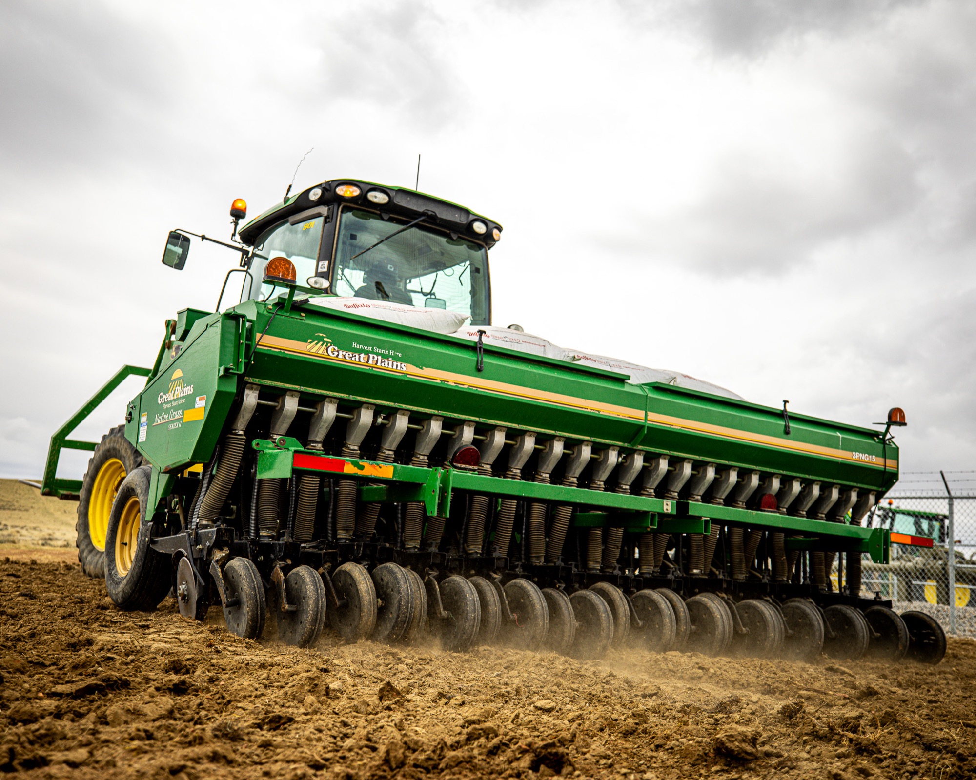 Great Plains drill seeder working reclaimed oilfield site