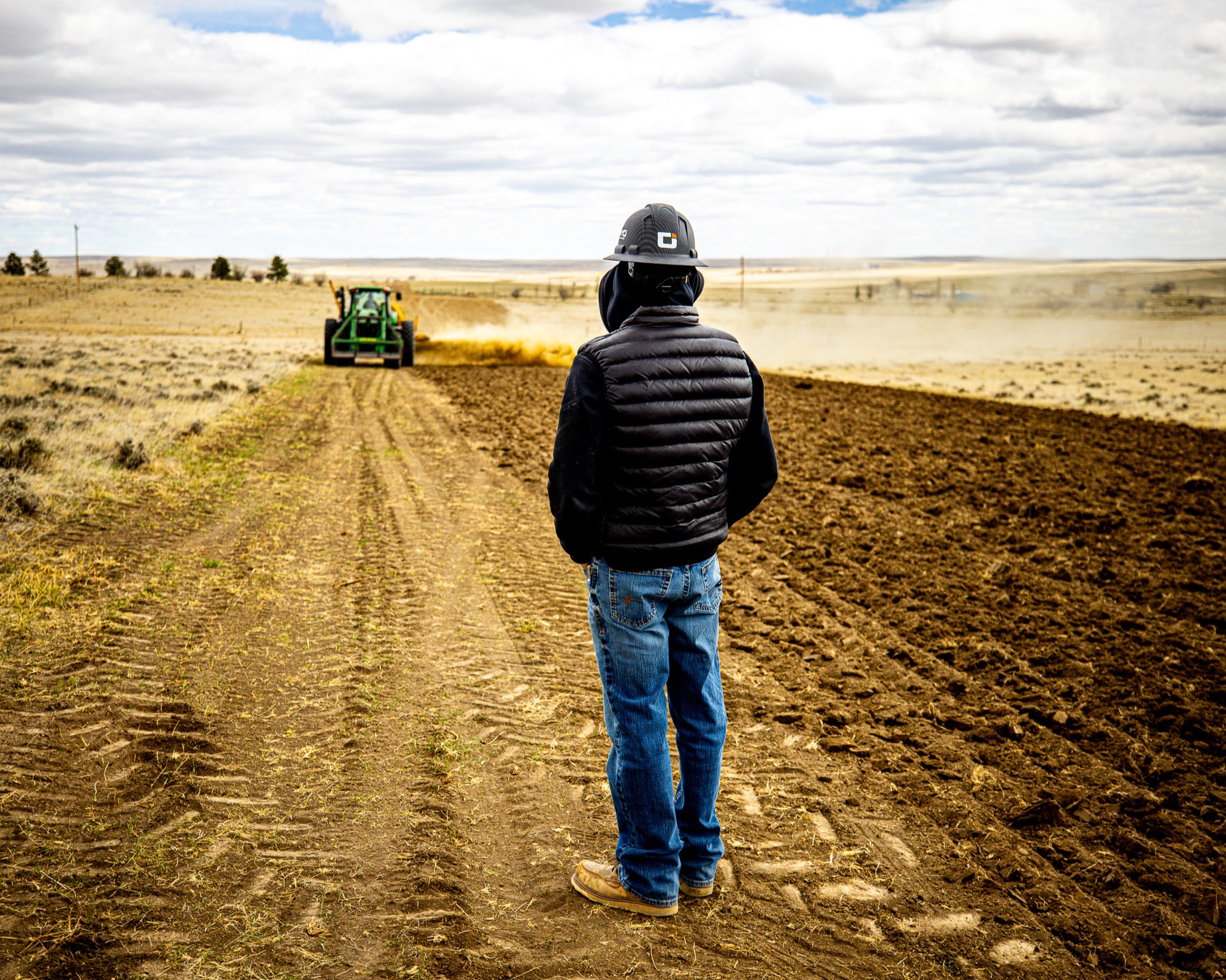 WYO Services crew member watching tractor work a reclamation site